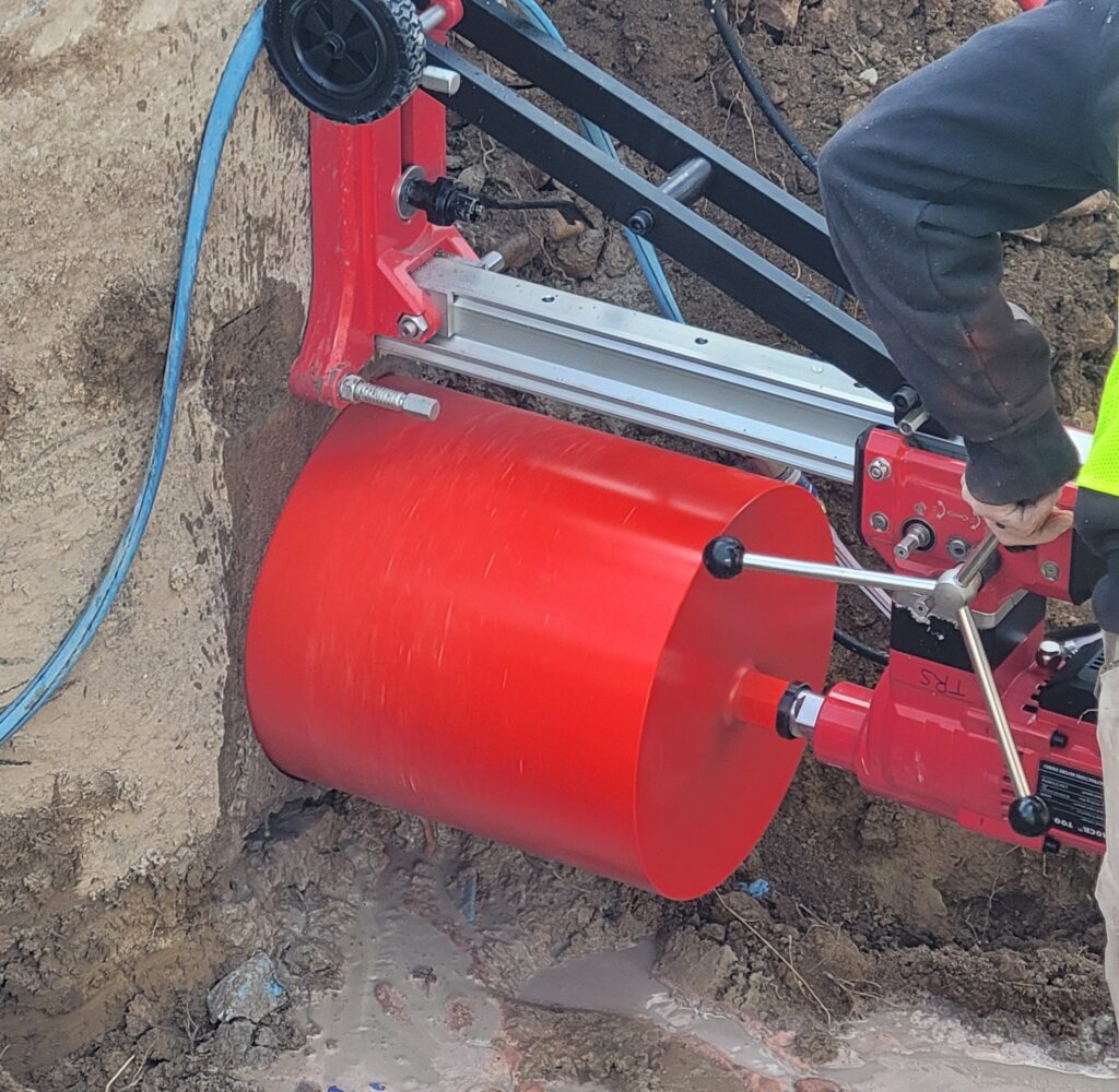 Large-diameter concrete core drilling in Utah using a mounted diamond core drill on a foundation wall